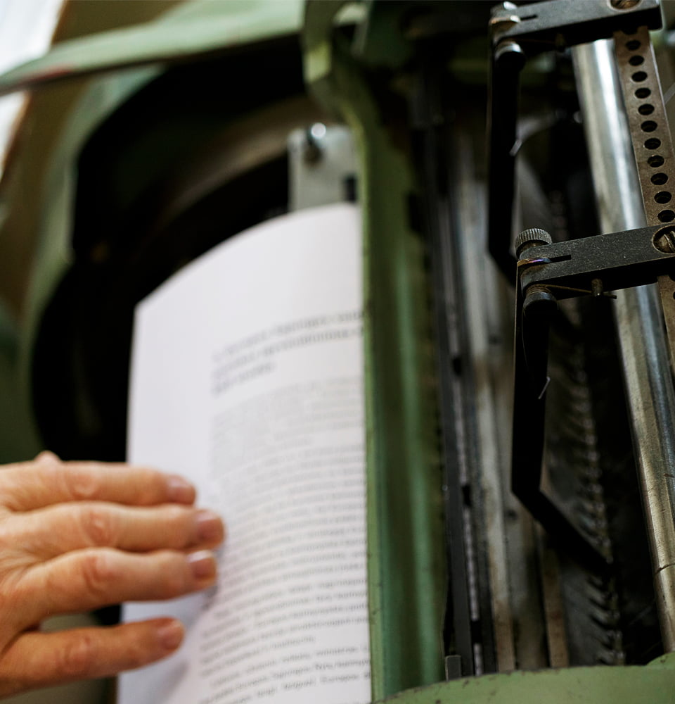 Hand holding a printed book